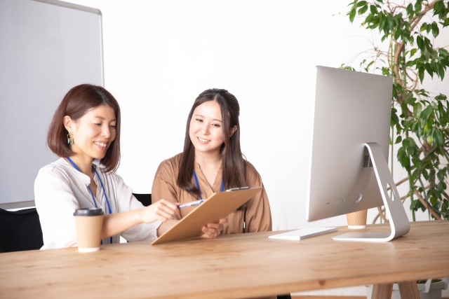 社内研修の振り返りをしている二名の女性